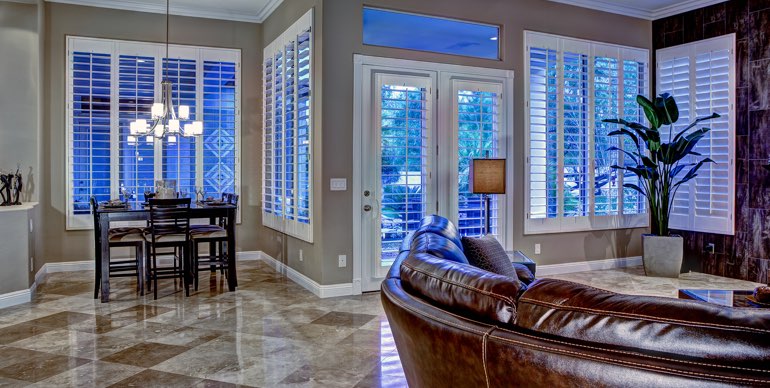 Destin great room with plantation shutters and tile floor.